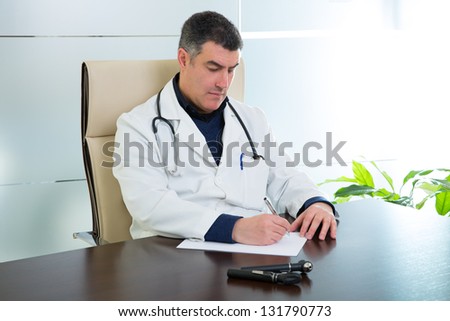 Doctor man expertise sitting in hospital office desk portrait