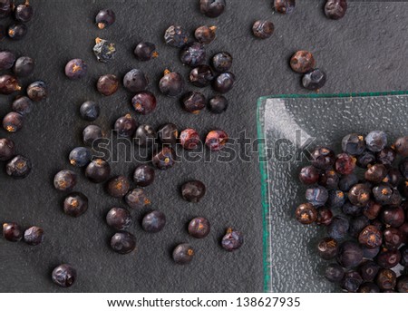 juniper berries macro detail closeup on black slate stone background