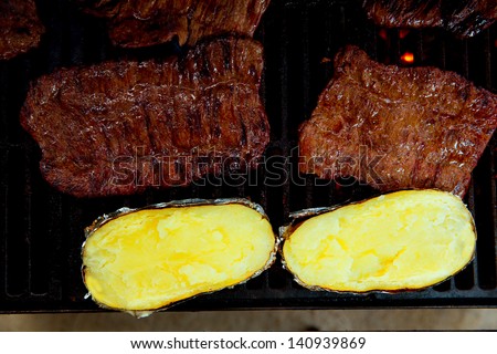 Barbecue grilled beef meat and potatoes prepared with cream and cheese