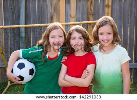 three sister girls friends soccer football winner players on the backyard