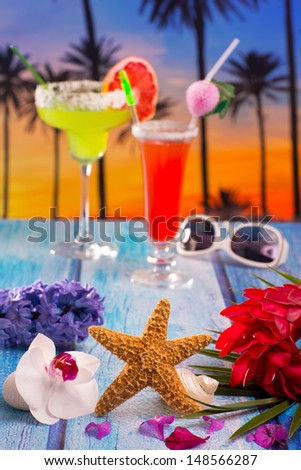 Cocktails margarita sex on the beach colorful tropical palm tree sunset sky with flowers and starfish