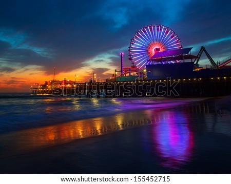 Santa Monica California sunset on Pier Ferrys wheel and reflection on beach wet sand