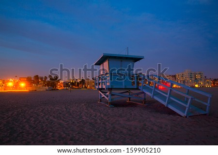 Santa Monica California sunset lifeguard tower and glowing city in USA