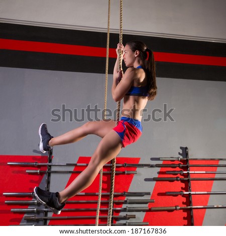 Rope Climb exercise woman workout at gym climbing