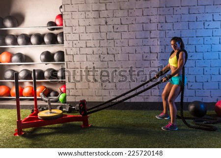 sled rope pull woman pulling weights workout exercise
