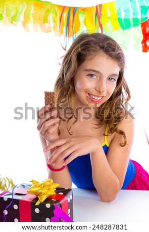 happy party girl with presents eating chocolate in birthday dirty mouth