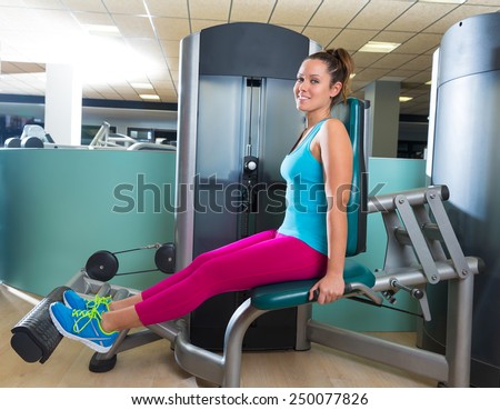 Calf extension woman at gym exercise machine workout indoor