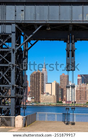 Manhattan New York skyline sunny from East River floodgates structure USA