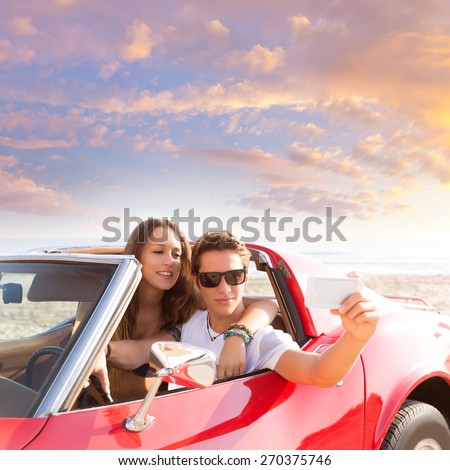 selfie photo of young teen couple in convertible sports car