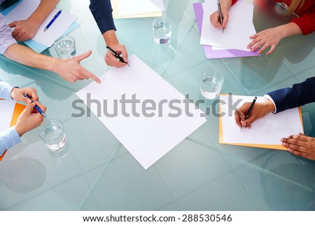 Business meeting teamwork aerial table view with hands pen and papers at office