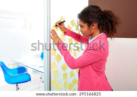 African ethnic executive with stickers in office young business woman