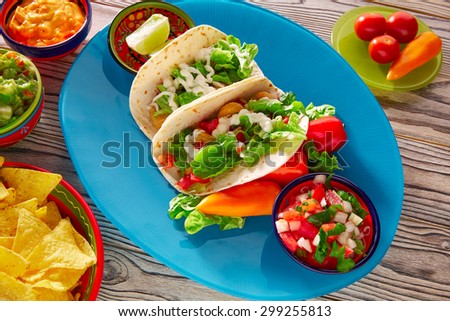 Fish tacos mexican food with guacamole nachos and chili pepper sauce