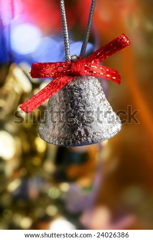 Silver bell in the christmas tree with red ribbon, xmas card
