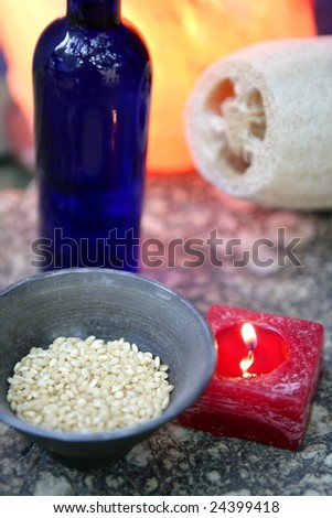 Aromatherapy, red candle, marine natural sponge and bowl of rice