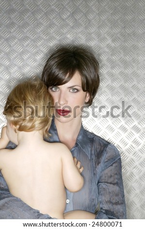 Metallic beautiful woman hug a nude baby over steel background