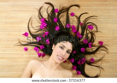 Beautiful indian woman portrait in a beauty spa with bougainvillea flowers