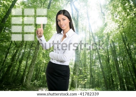 Brunette ecological businesswoman touching transparent key pad, ecology symbol [Photo Illustration]