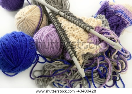 colorful knitting tools with wool thread balls
