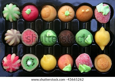 Colorful marzipan sweets with fruits shapes made of almond and sugar