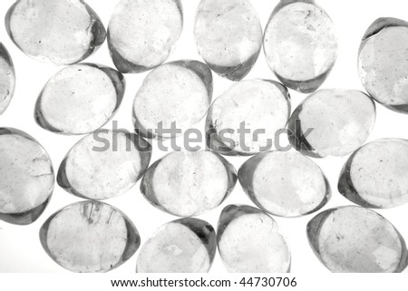 Glass transparent oval marbles over white background