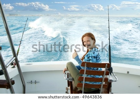 fisherwoman big game on boat chair ok sign happy