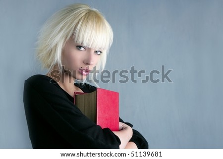 blonde fashion student holding red book