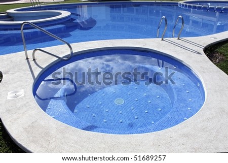 blue swimming pool round shapes and outdoor jacuzzi