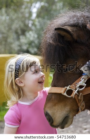 little blond girl loves her pony funny portrait