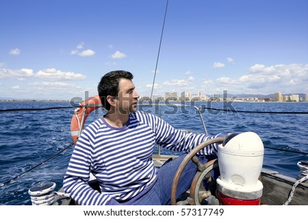 blue sailor man sailing vintage wooden sailboat mediterranean sea