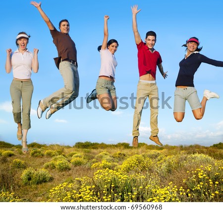 Jumping young people happy group in yellow flowers field [Photo Illustration]