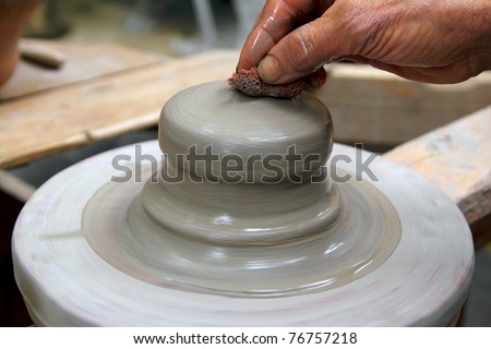 man potter hands working on pottery clay wheel stoneware sponge