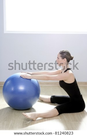instructor woman with stability ball doing gym fitness yoga exercises