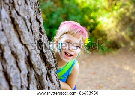 children little girl happy playing in forest tree with party makeup