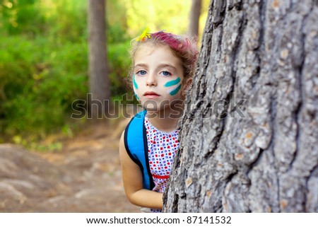 children little girl playing in forest tree with party makeup
