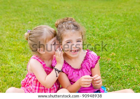 children girl sister friends whispering ear in green grass park