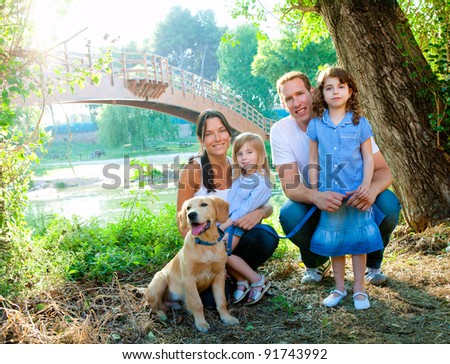 Happy family father mother kids and dog outdoor river park