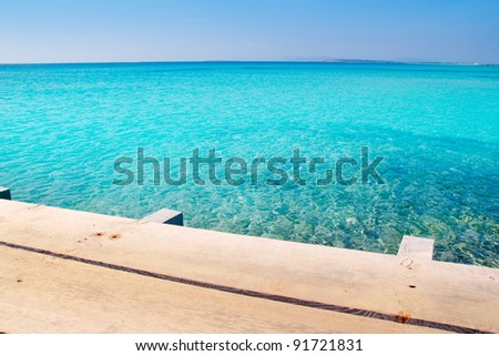 Formentera beach wood pier over turquoise water from balearic Mediterranean sea paradise