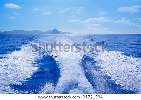 Es Vedra islet and Vedranell islands with boat wake in mediterranean Spain