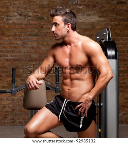 fitness shaped muscle man posing on dark gym