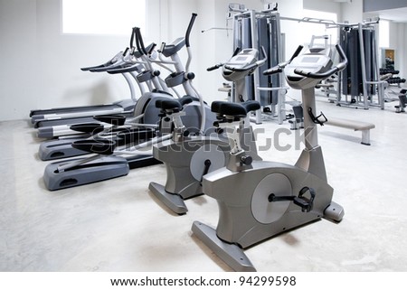 elliptical cross trainer, stationary bicycle and treadmill in gym