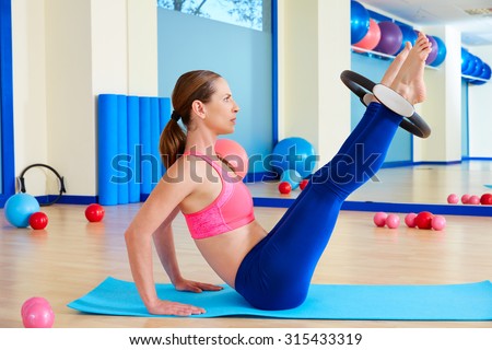 Pilates woman hip twist magic ring exercise workout at gym indoor