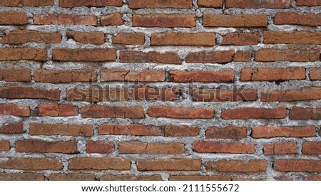 Red brick masonry wall, uneven, broken and black burnt bricks, bright red brick background , natural red brick wall abstract wallpaper background. unfinish wall construction.