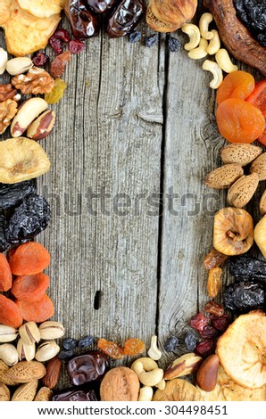 Mix of dried fruits and nuts - symbols of judaic holiday Tu Bishvat. Copyspace background. Top view. Vertical.