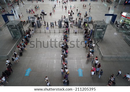 SHANGHAI, CHINA - August 16: crowd of passengers waits for a transport on one of the four major railway stations in Shanghai - Shanghai Hongqiao Railway Station on August 16. 2014 in Shanghai
