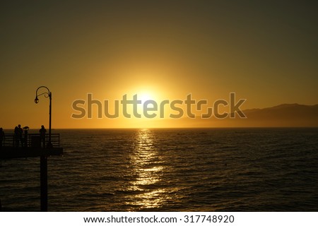 Sunset on Beach with Horizon Line - Pacific Ocean Waves on West Coast in Santa Monica California.