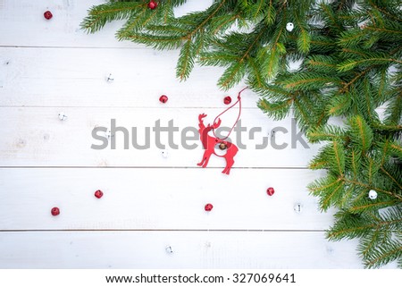 red wooden deer, pine brunches, res and white bells.christmas decoration
