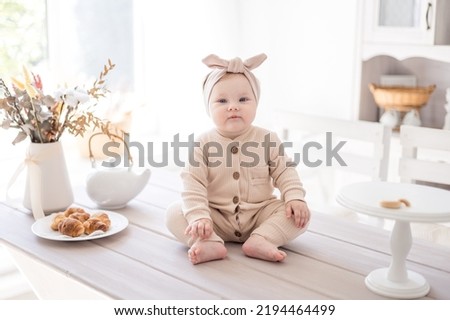 Similar – Image, Stock Photo A charming baby is watering a strawberry bush in the garden from a children’s toy watering can. Childhood, sun, summer, gardening