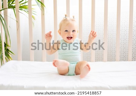 Similar – Image, Stock Photo Young toddler standing up looking at a fabric children’s book; eclectic decor with house plants