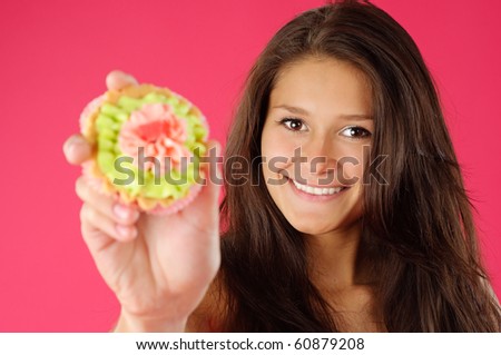 Young woman glad to offer you a delicious cake