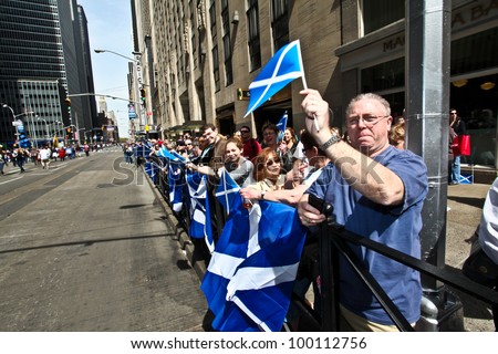 NEW YORK - APRIL 14:  People holding Scottish Flags watch the parade pass on on 6th Avenue April 14, 2011 in New York, NY.